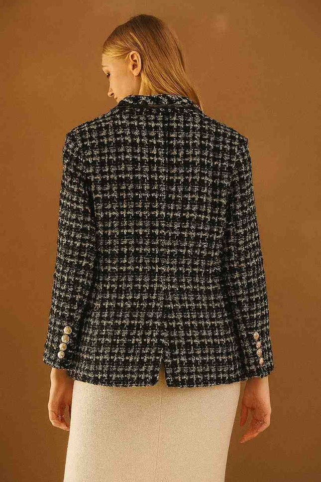 Person wearing a black and white checkered blazer