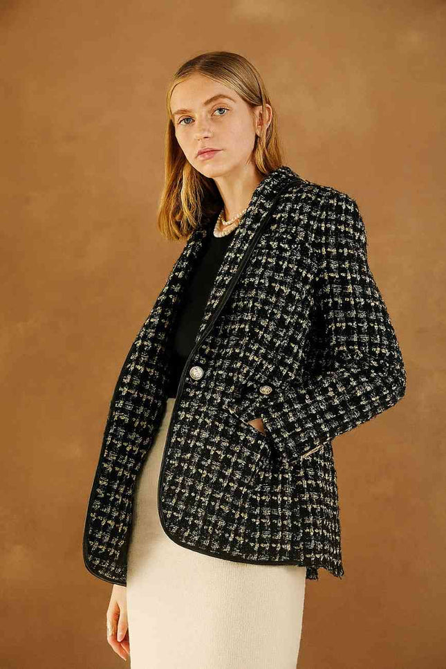 Woman wearing a black and white checkered blazer 