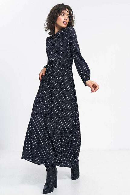 Nife polka dot maxi dress in black featuring long sleeves and a cinched waist for a stylish look