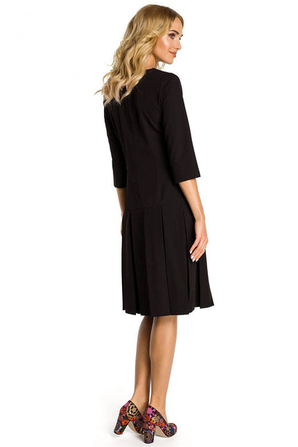 Black Moe pleated midi dress featuring a chic design and elegant silhouette, perfect for any occasion.