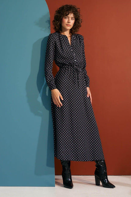 Nife polka dot maxi dress with a cinched waist and long sleeves, perfect for stylish occasions