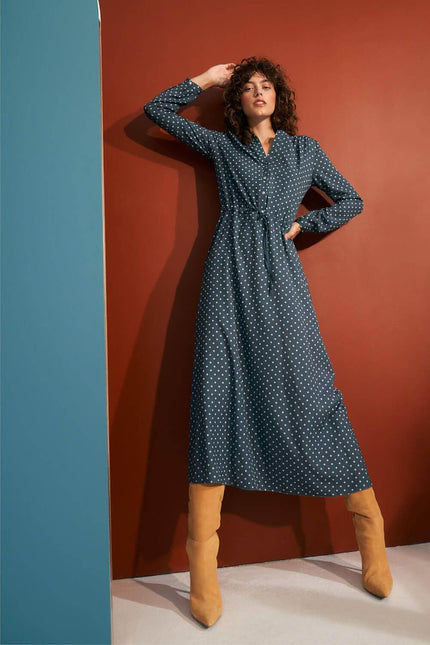 Nife polka dot maxi dress featuring a tie waist and long sleeves, perfect for stylish occasions